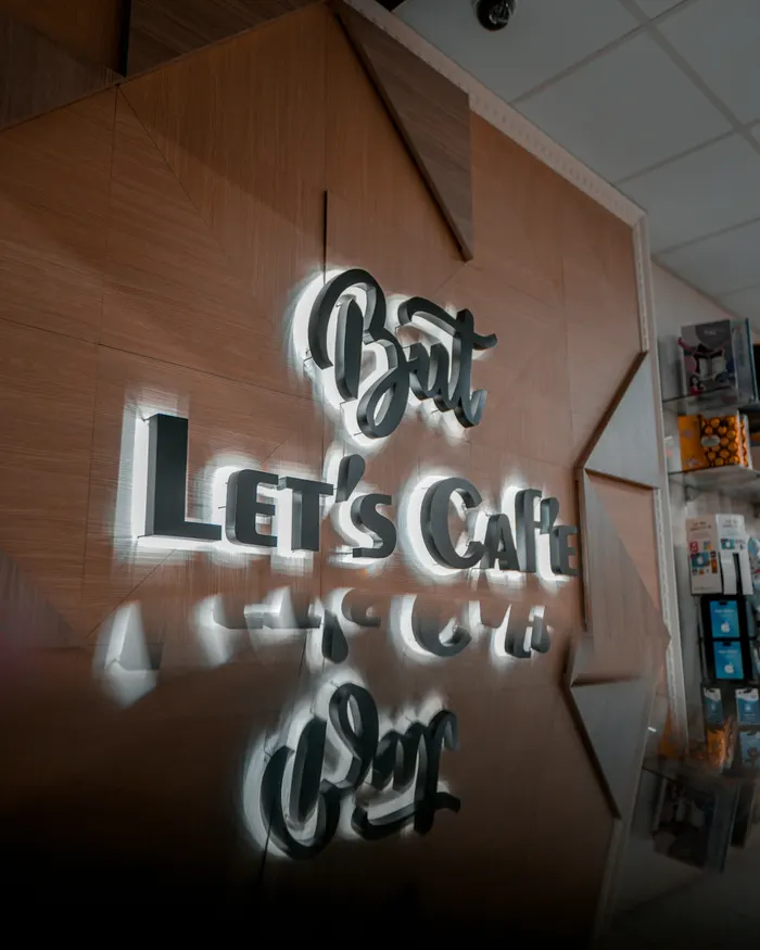 Profile cut lettering and logo signage mounted to a business frontage