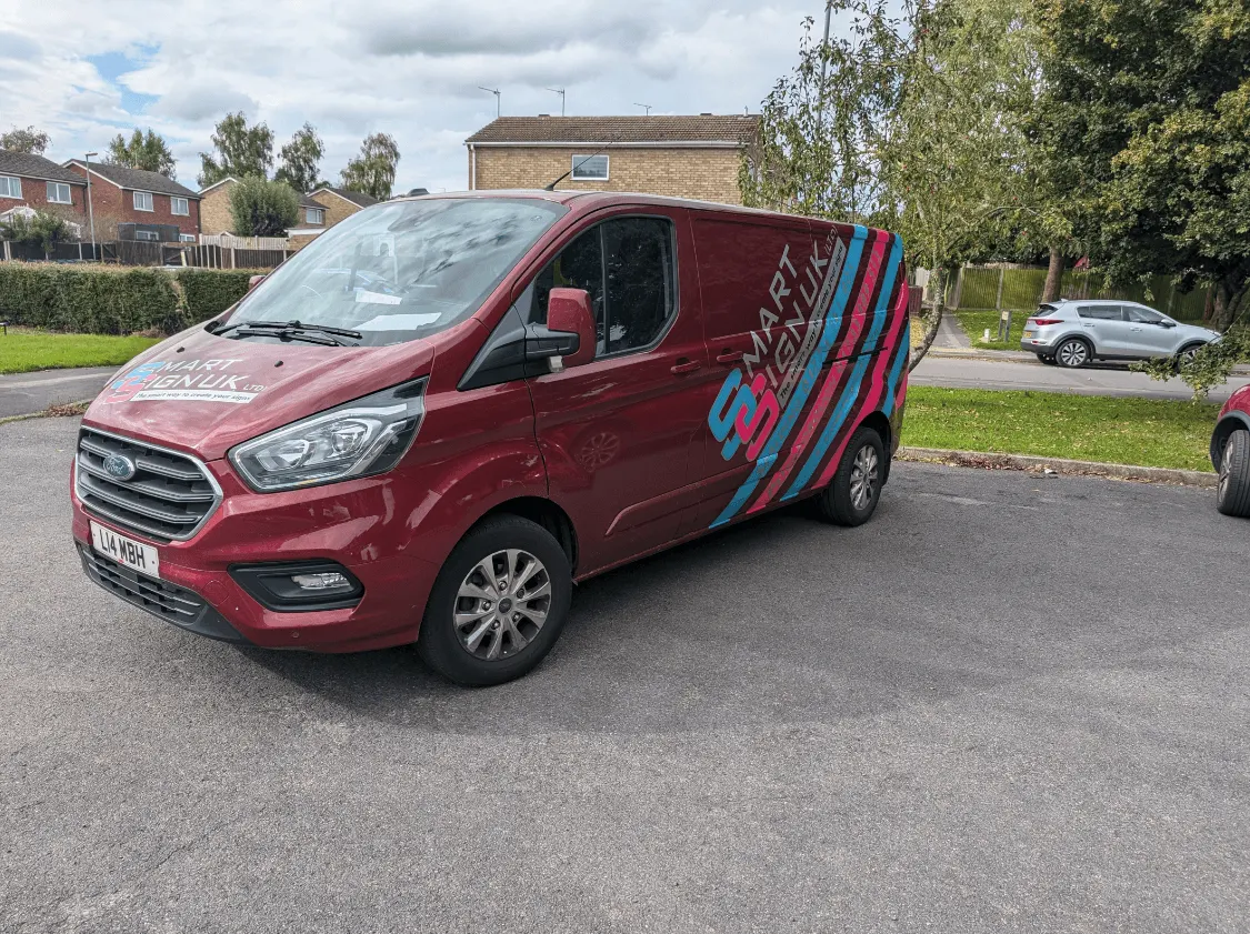 Smart Sign UK van fitted with red, teal and pink vehicle graphics